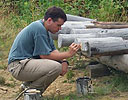 A Voulteer paints posts